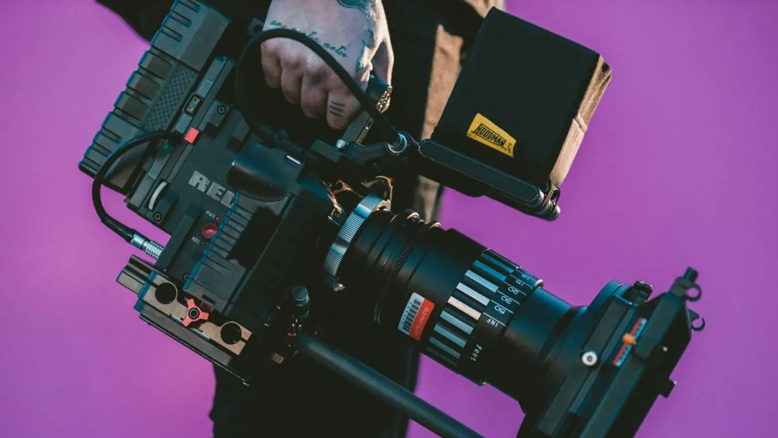 A person holding a professional video camera