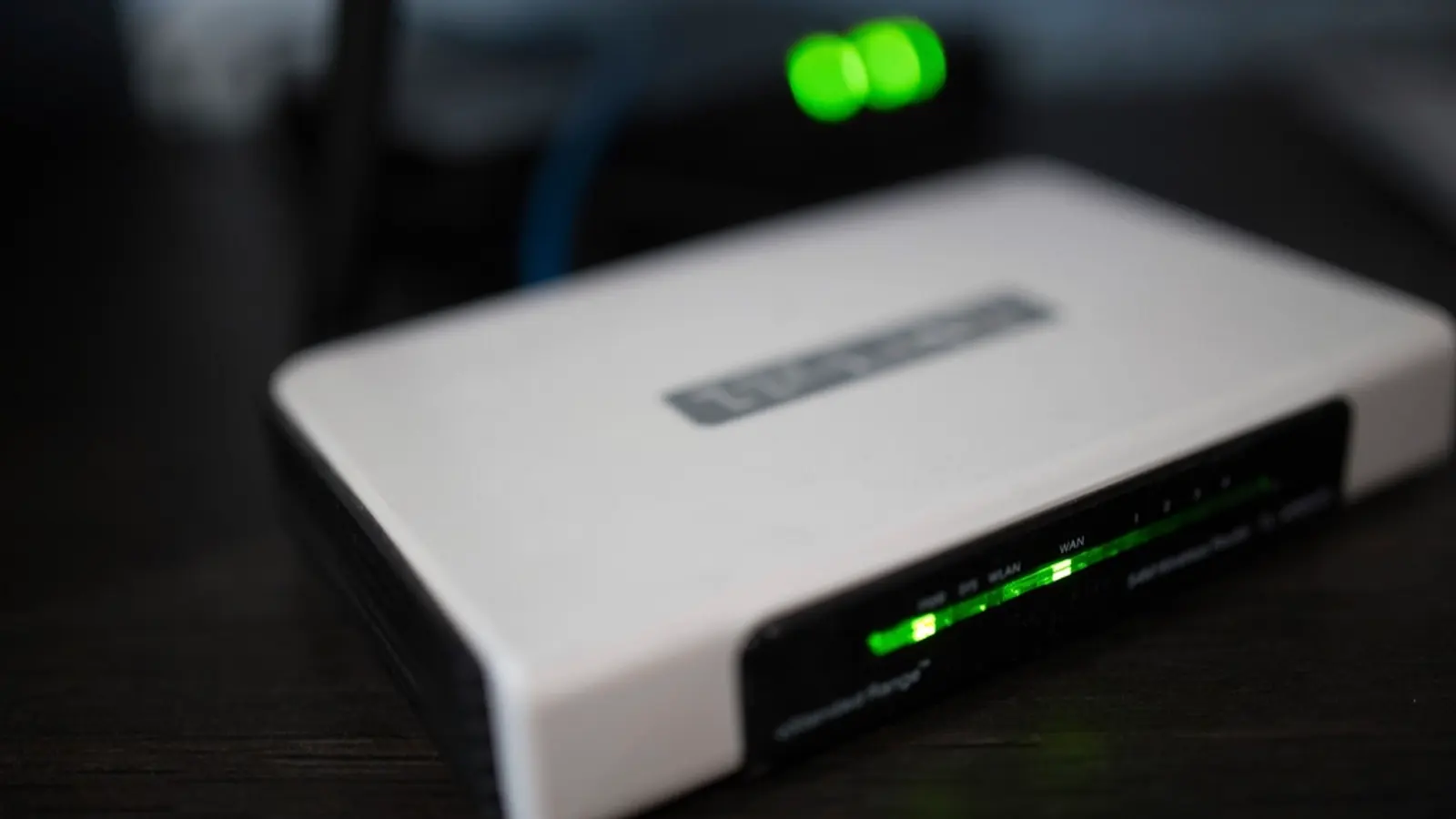 A home router with green status lights glowing