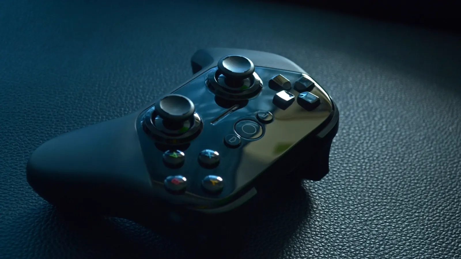 A game controller resting on a dark fabric surface