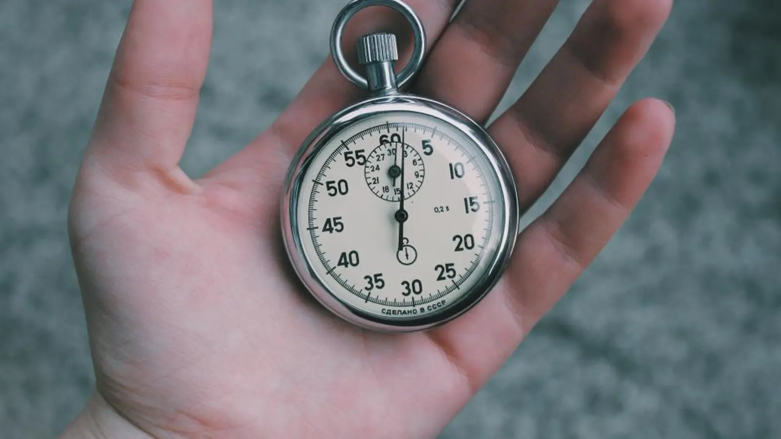 A stopwatch resting in the palm of a hand
