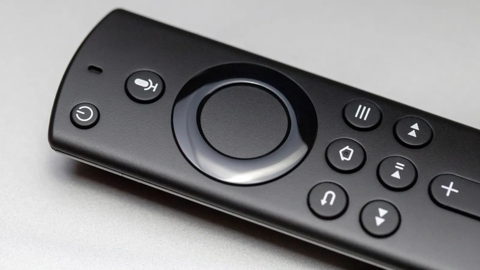 Close-up of a black voice remote with navigation ring and buttons