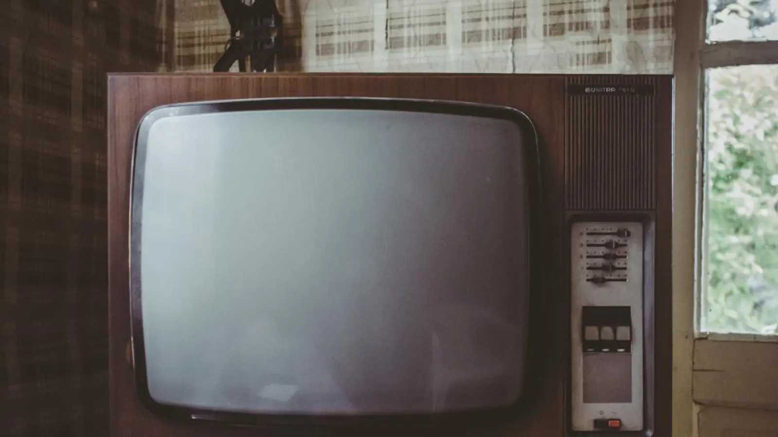 A vintage television set in a wooden cabinet