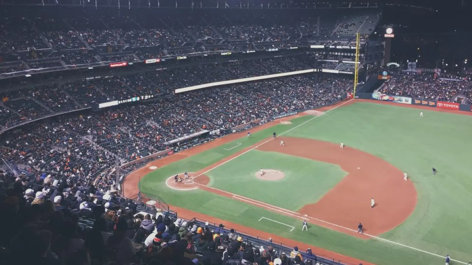 A baseball stadium under floodlights at night