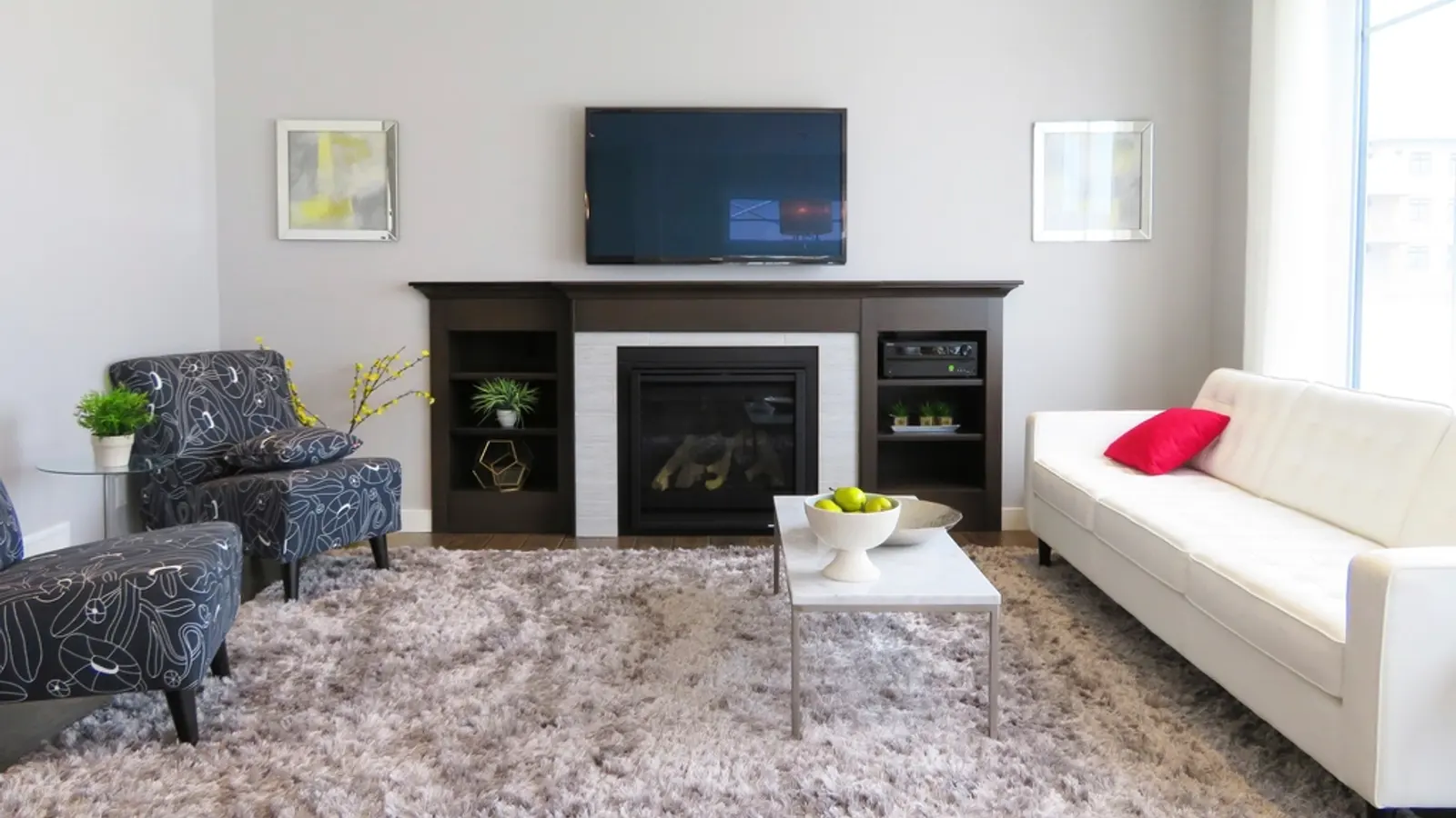 A living room with a TV mounted above a fireplace